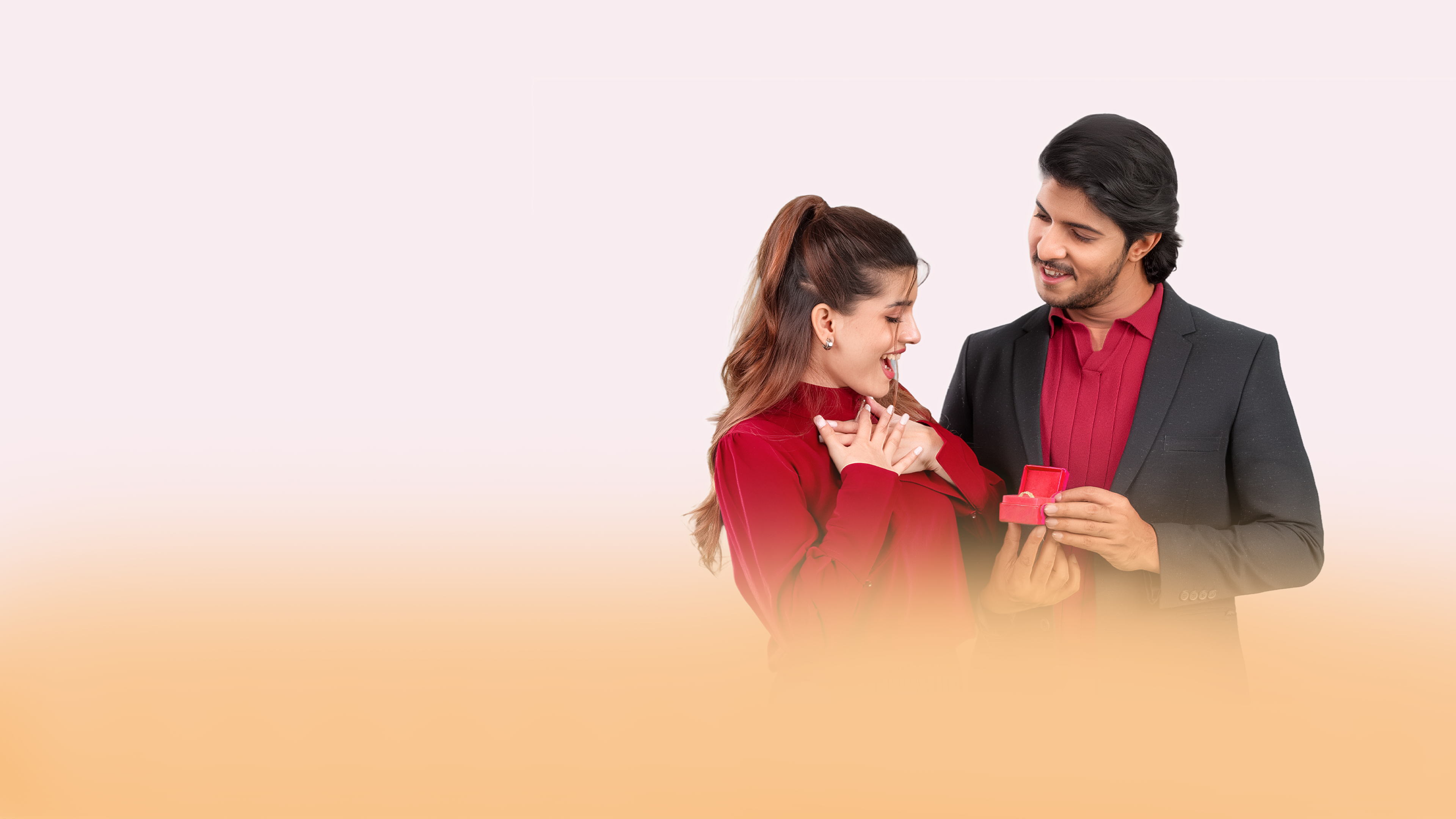 A man offering a ring to a delighted woman